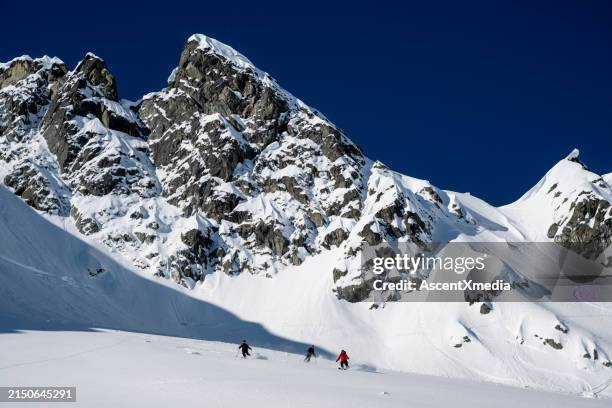 group of ski mountaineers descend slope - off piste ski stock pictures, royalty-free photos & images