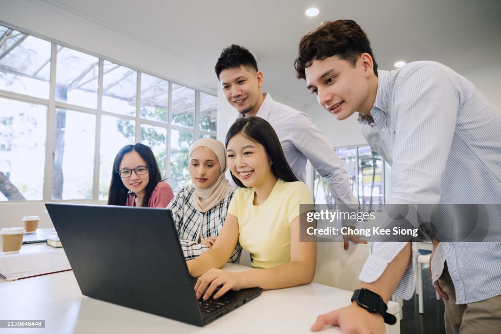 Young Asian Business Team Working Together.