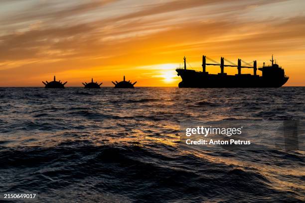cargo ship and naval mines in black sea - mer noire photos et images de collection