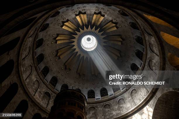 Light shines over the Edicule, traditionally believed to be the burial site of Jesus Christ, at the Church of the Holy Sepulchre in the Old City of...