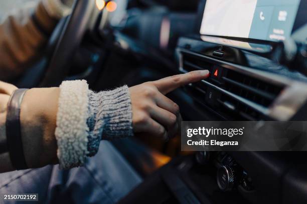 pushing car flashers button on dashboard - car blinker stock pictures, royalty-free photos & images