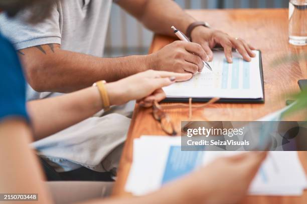 couple, hands and sign of document, table and legal in office, life cover or insurance with pen. paperwork, people and agreement of contract, glasses and together for marriage, love and retirement - erfenis stockfoto's en -beelden