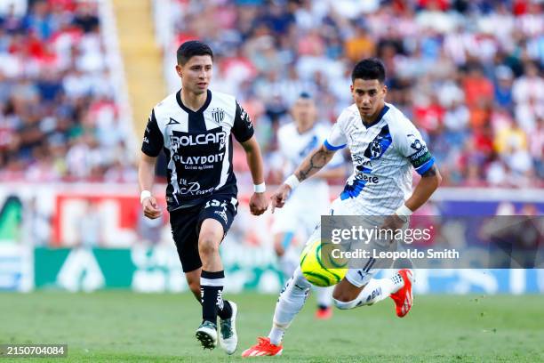 Brayan Garnica of Necaxa competes for the ball with Maximiliano Meza of Monterrey during the 17th round match between Necaxa and Monterrey as part of...