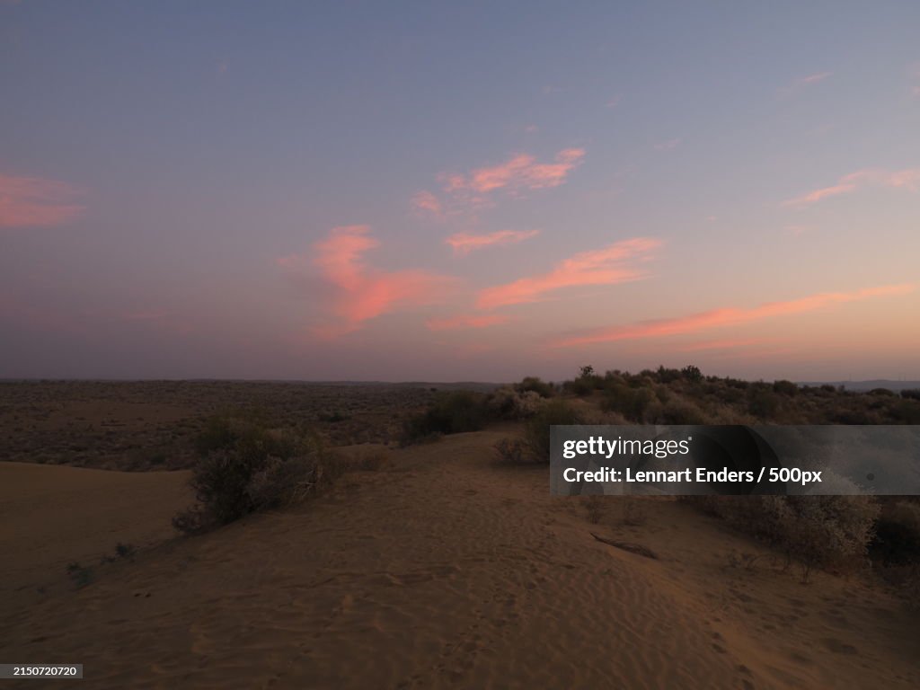 Scenic view of desert against sky during sunset