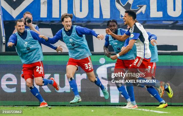 Hamburg's German forward Robert Glatzel celebrates scoring his team's first goal with team mates during the Bundesliga second division football match...