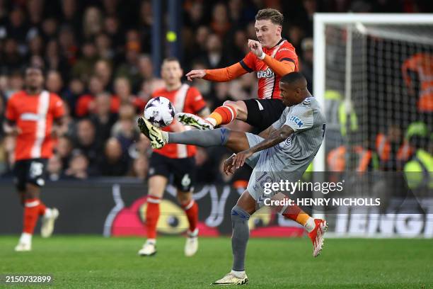 Everton's English defender Ashley Young vies with Luton Town's English midfielder Alfie Doughty during the English Premier League football match...
