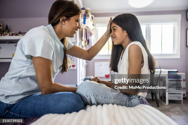 mother talking with young daughter in her room - stay at home saying stock pictures, royalty-free photos & images