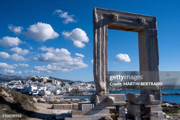 Temple of Apollo, also known as Portara, on a peninsula in the town of Chora in Naxos, an island in the Cyclades archipelago in the Aegean Sea in the...