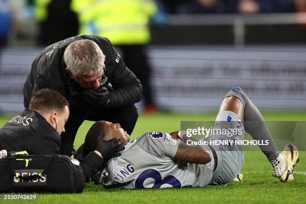 Everton's English defender Ashley Young is treated by medical staff during the English Premier League football match between Luton Town and Everton...