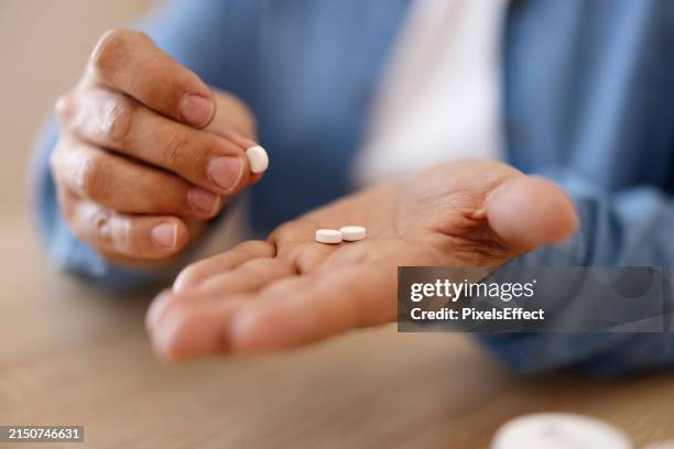 cropped view of patient hand with pills at home - acetylsalicylizuur stockfoto's en -beelden