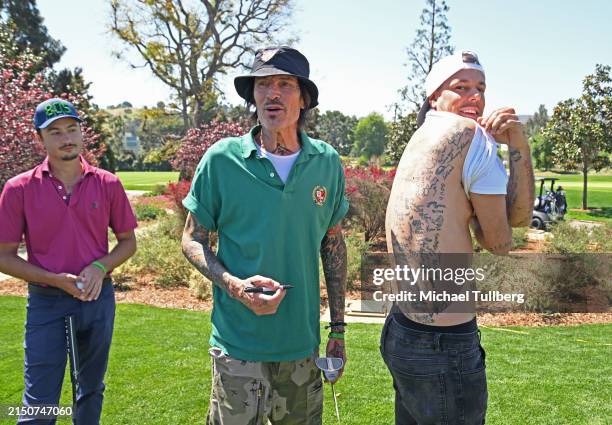 Musician Tommy Lee autograph's a fan's back at the George Lopez Foundation's 17th annual Celebrity Golf Classic at Lakeside Golf Club on April 29,...