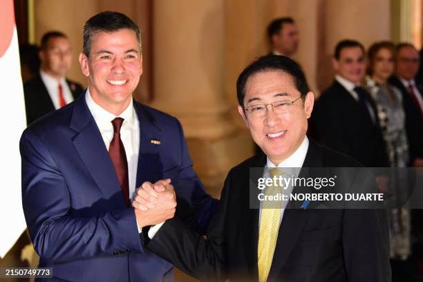 Japan's Prime Minister Fumio Kishida and Paraguay's President Santiago Peña shake hands during a welcome ceremony at Lopez Presidential Palace in...