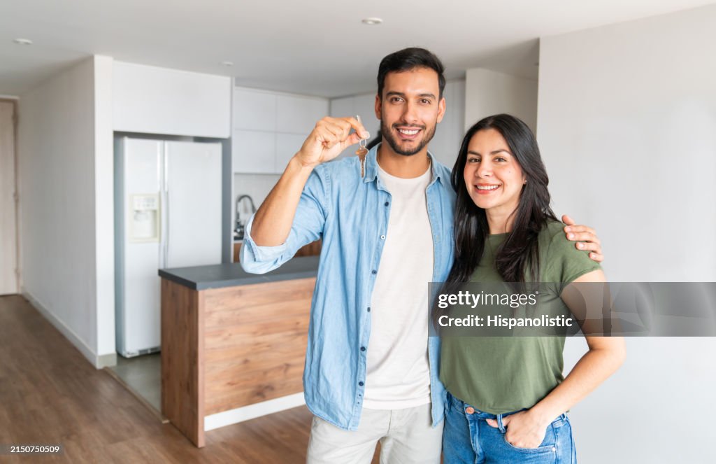 Loving couple holding the keys of their new house