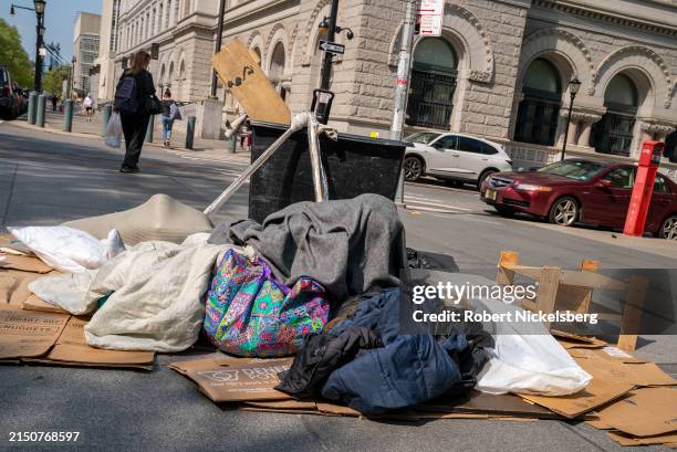 Homeless man spreads his belongings April 29, 2024 at Cadman Plaza in New York City. New York City has more 93,000 homeless people.