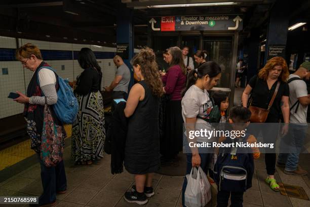 Subway passengers wait for a downtown train April 29, 2024 in New York City. New York City's subway daily ridership is approximately 3.2 million...