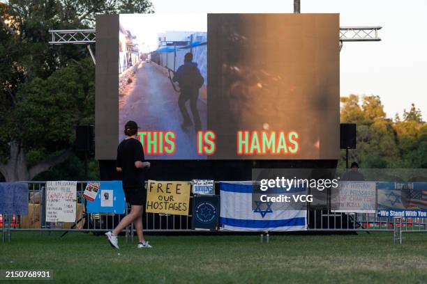Pro-Israel demonstrators play a video called 'This is Hamas' across from the pro-Palestinian encampment at the University of California in Los...