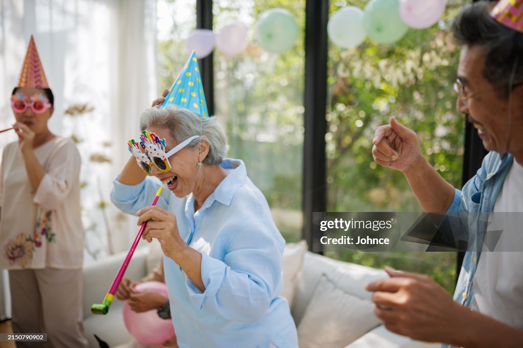 Joyful seniors preparing a birthday party