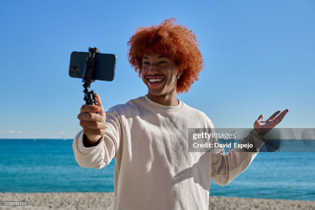 Joyful blogger recording at beach