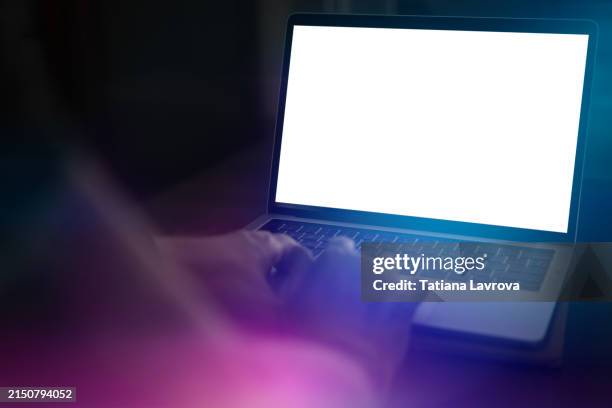 analyzing data on a laptop screen in a dimly lit room at night. view from behind the shoulder. man's hands typing on the keyboard - web page stock pictures, royalty-free photos & images