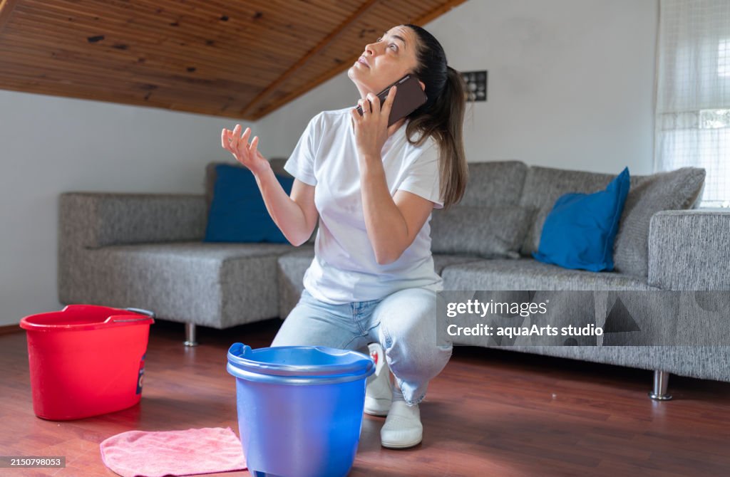 Woman Calling Insurance Assistance For Roof Leaking