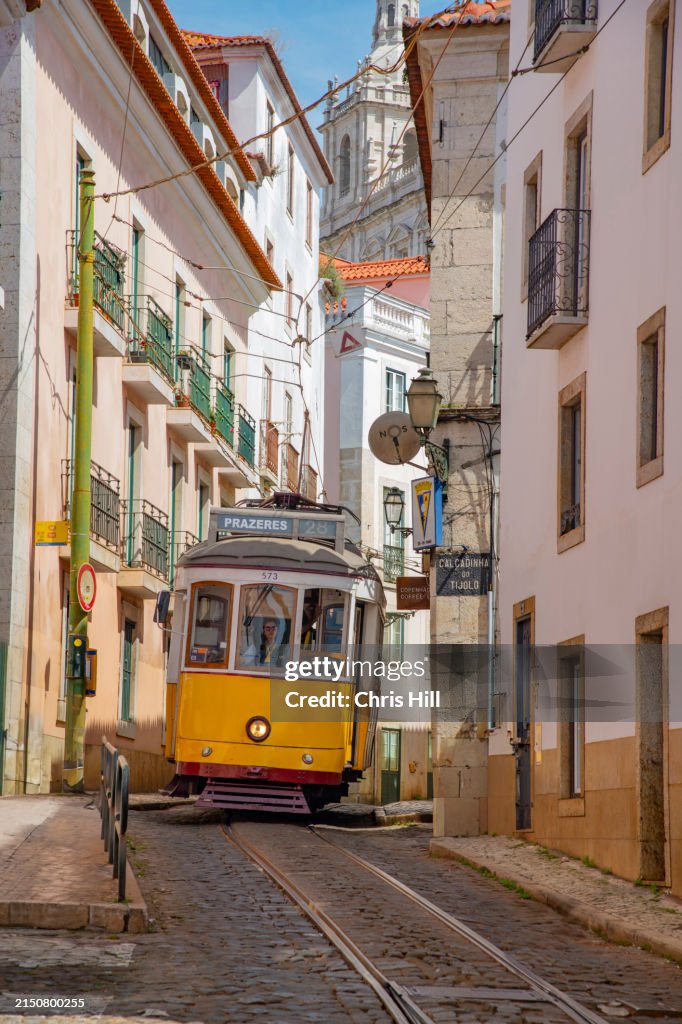 The iconic No 28 Yellow Tram on the streets in Alfama, Lisbon, Portugal