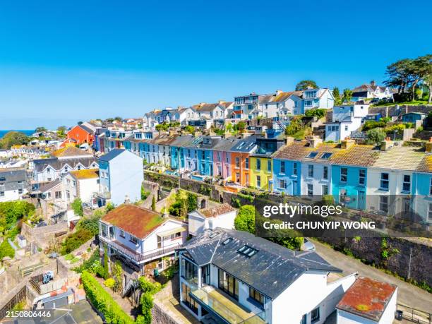 cute colorful coastal houses on the hill in brixham town in england - clear sky beautiful landscape stock pictures, royalty-free photos & images