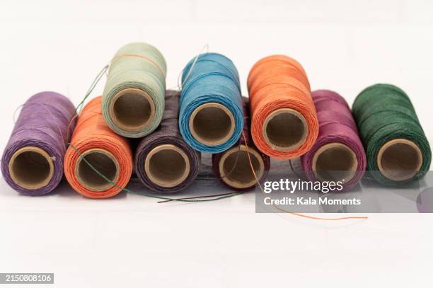 spools of coloured thread in a row. colorful yarn - ball of wool stock pictures, royalty-free photos & images