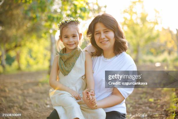 carefree young mother and daughter hugging in spring day. - kid reaction portrait stock pictures, royalty-free photos & images