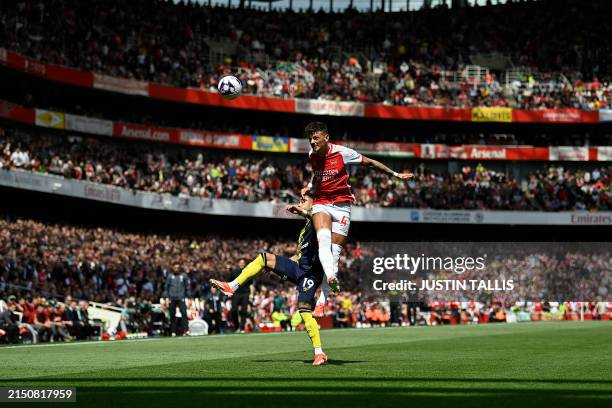Arsenal's English defender Ben White jumps above Bournemouth's Dutch striker Justin Kluivert to header the ball during the English Premier League...