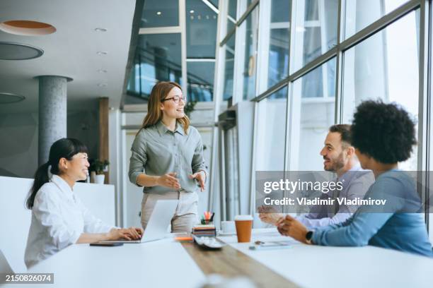 vibrant office meeting with the animated speaker - formal businesswear stock pictures, royalty-free photos & images