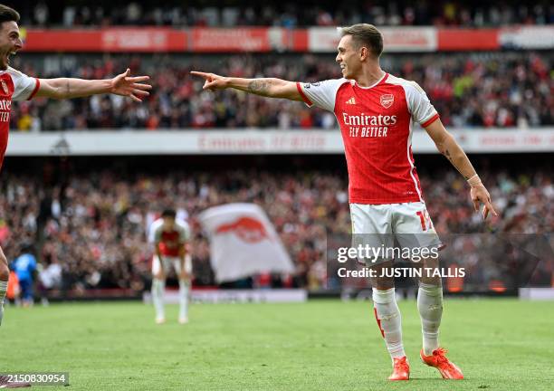 Arsenal's Belgian midfielder Leandro Trossard celebrates with Arsenal's English midfielder Declan Rice after scoring the team's second goal during...