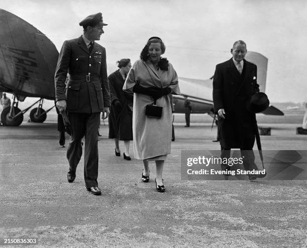 Queen Juliana of The Netherlands accompanied by a Royal Air Force officer after arriving at London Airport, May 12th 1954.