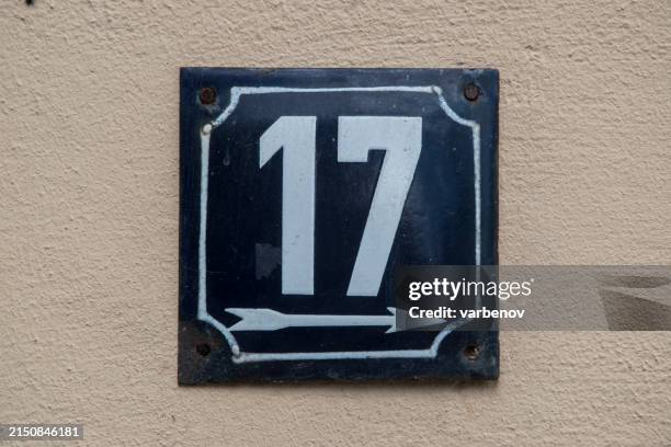 Weathered metal plate of number of street address number 17