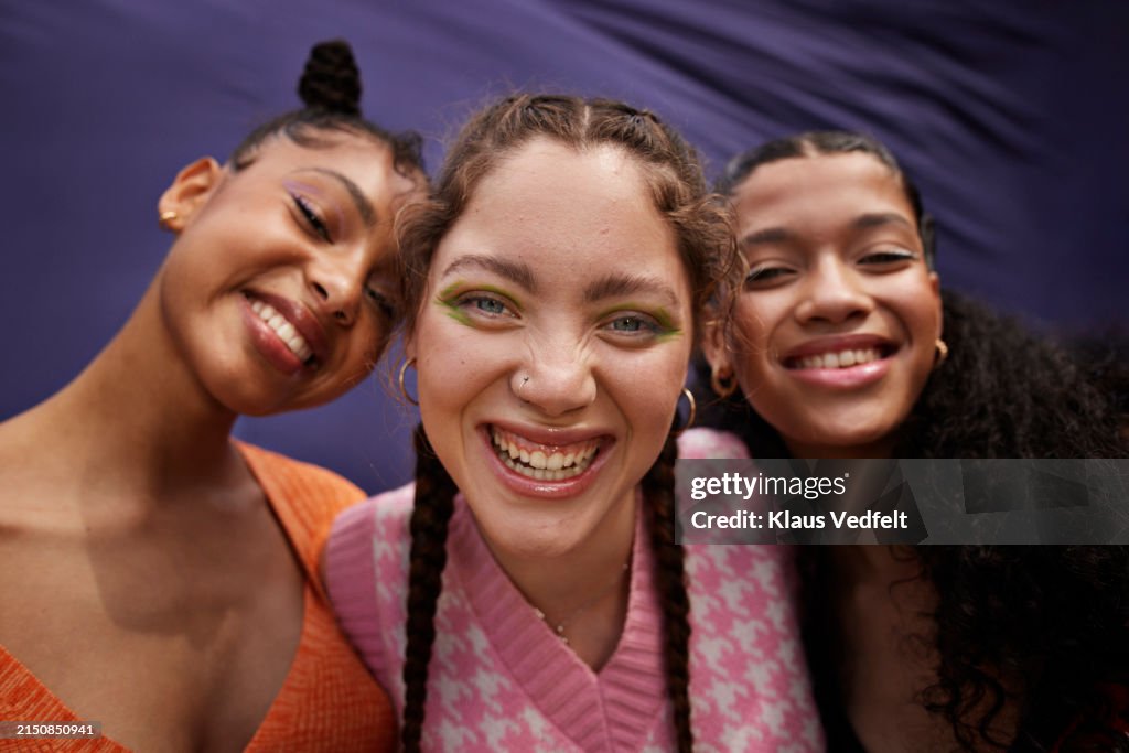 Cheerful young woman and teenage girls with eyeshadow