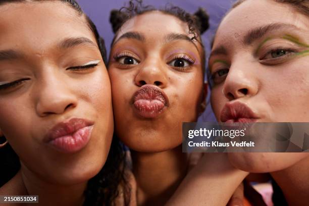 teenage girls and young woman puckering lips - lippen stock-fotos und bilder