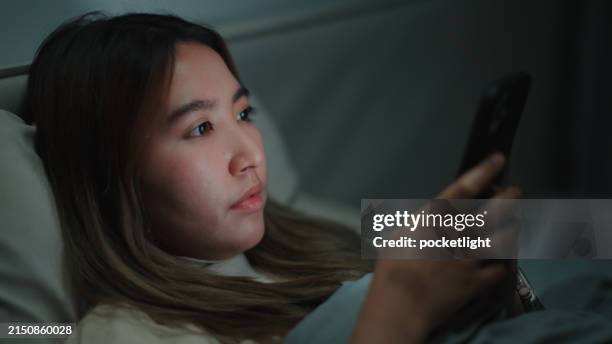 woman using smartphone at night. - phone screen reflection stock pictures, royalty-free photos & images