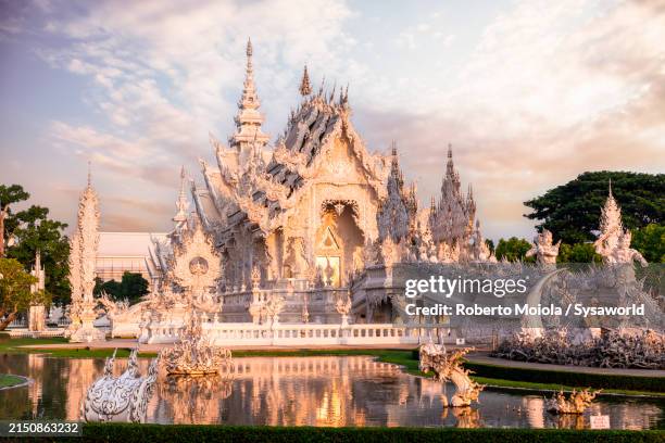 white temple (wat rong khun) reflected in water - chiang rai province stock pictures, royalty-free photos & images