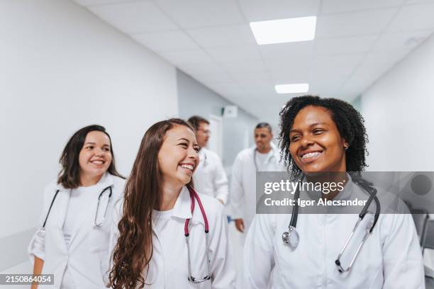 smiling female healthcare professionals on the way - medisch student stockfoto's en -beelden