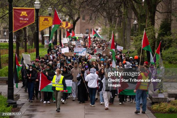 Demonstrators marched on the Northrop Mall before setting up tents on the lawn. A few hundred people gathered outside Coffman Memorial Union to call...