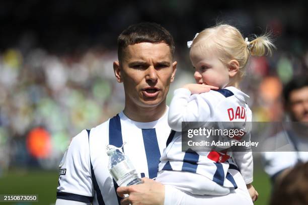 Conor Townsend of West Bromwich Albion walks out of the players tunnel with their children ahead of the Sky Bet Championship match between West...