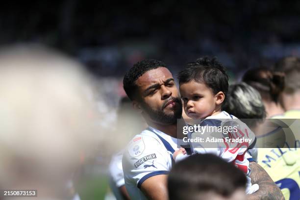 Darnell Furlong of West Bromwich Albion walks out of the players tunnel with their children ahead of the Sky Bet Championship match between West...