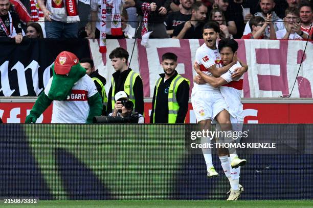 Stuttgart's South Korean midfielder Jeong Woo-yeong celebrates scoring his team's second goal with Stuttgart's German midfielder Mahmoud Dahoud...