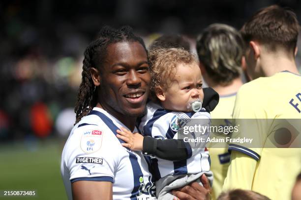 Brandon Thomas-Asante of West Bromwich Albion walks out of the players tunnel with their children ahead of the Sky Bet Championship match between...