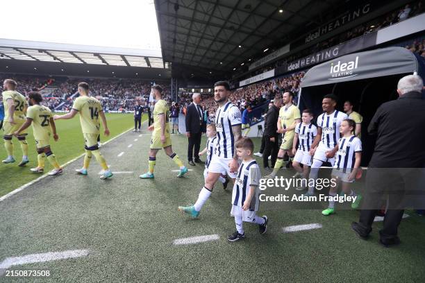 Alex Mowatt of West Bromwich Albion out of the players tunnel with Jed Wallace of West Bromwich Albion children ahead of the Sky Bet Championship...