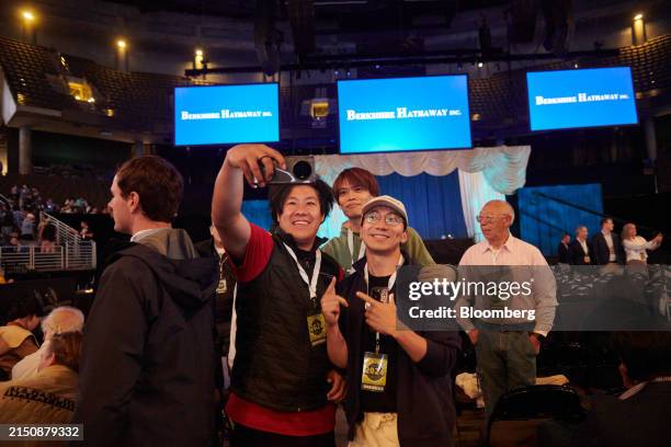 Attendees take a selfie photograph inside the CHI Health Center during the Berkshire Hathaway annual shareholders meeting in Omaha, Nebraska, US, on...