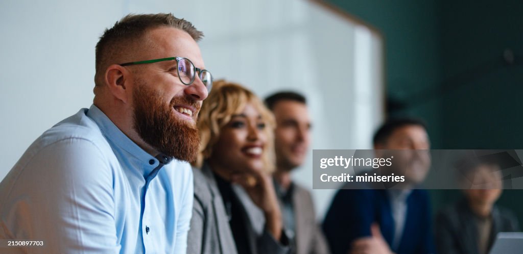 Businesspeople Listening To A Presentation In Their Office