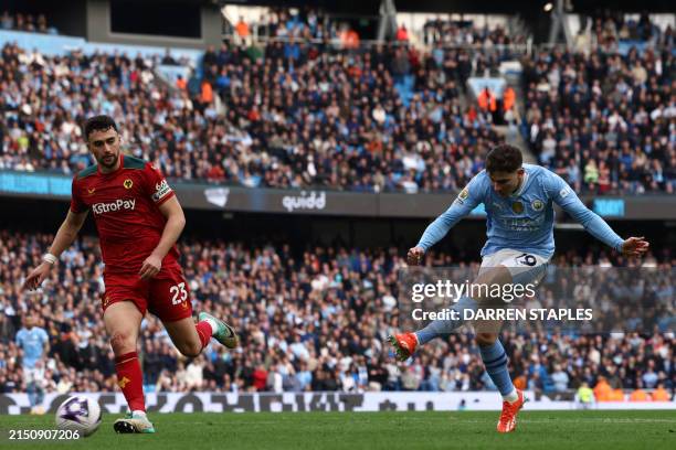 Manchester City's Argentinian striker Julian Alvarez shoots to score their fifth goal during the English Premier League football match between...