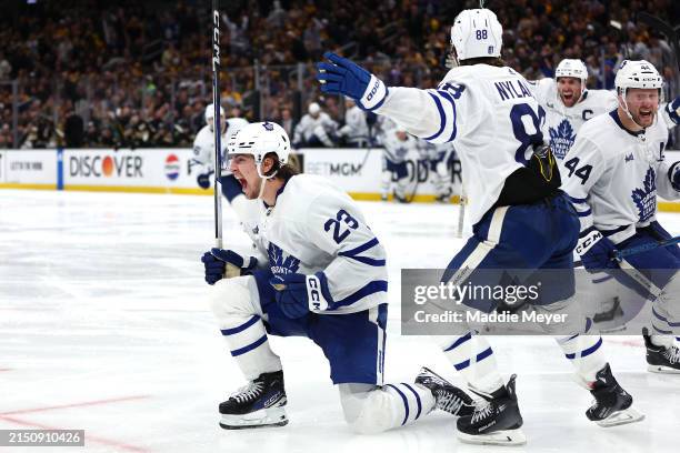 Matthew Knies of the Toronto Maple Leafs celebrates with William Nylander after scoring the game winning goal against the Boston Bruins to win the...