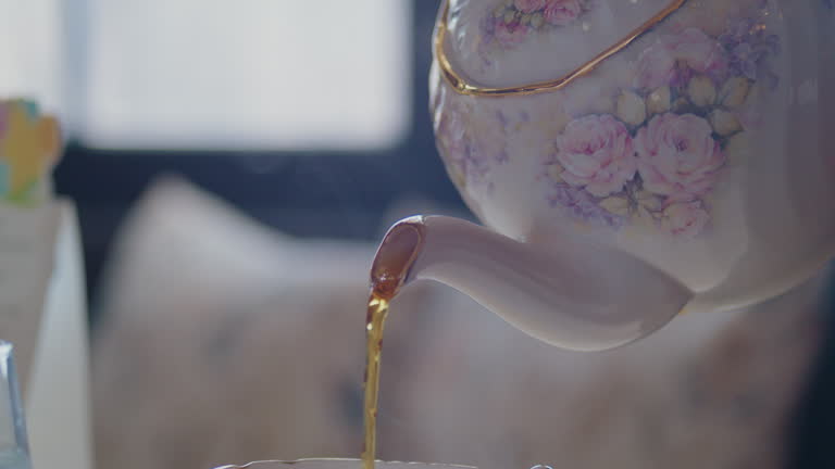 https://media.gettyimages.com/id/2150914375/video/window-lit-golden-rimmed-tea-pot-is-poured-into-a-beautiful-purple-flower-cup.jpg?b=1&s=640x640&k=20&c=CLr26RE8NnenlZUzlC9AgksPSZiFe9WHxIN2HAVCcSs=