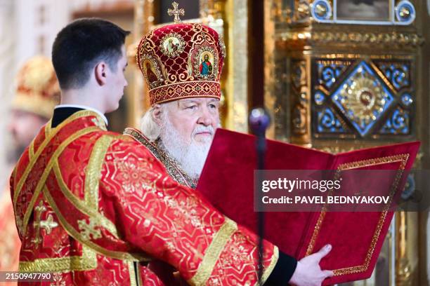 In this pool photograph distributed by Russian state agency Sputnik, Russia's Orthodox Patriarch Kirill leads an Orthodox Easter service at the...